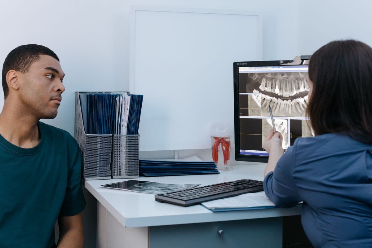 dental implant candidacy Kharghar dentist reviewing X-ray with patient