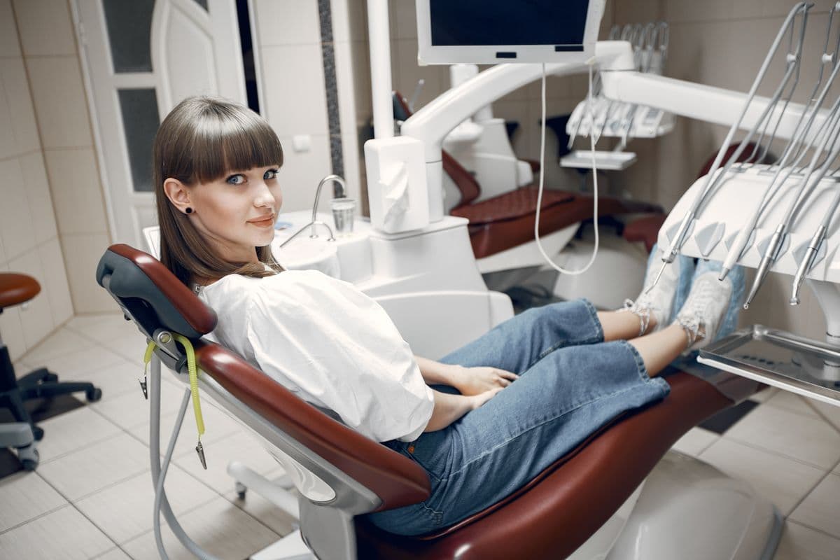 Dental implant recovery Kharghar — relaxed patient smiling in a modern dental clinic chair, Reform Dental Clinic Sector 15