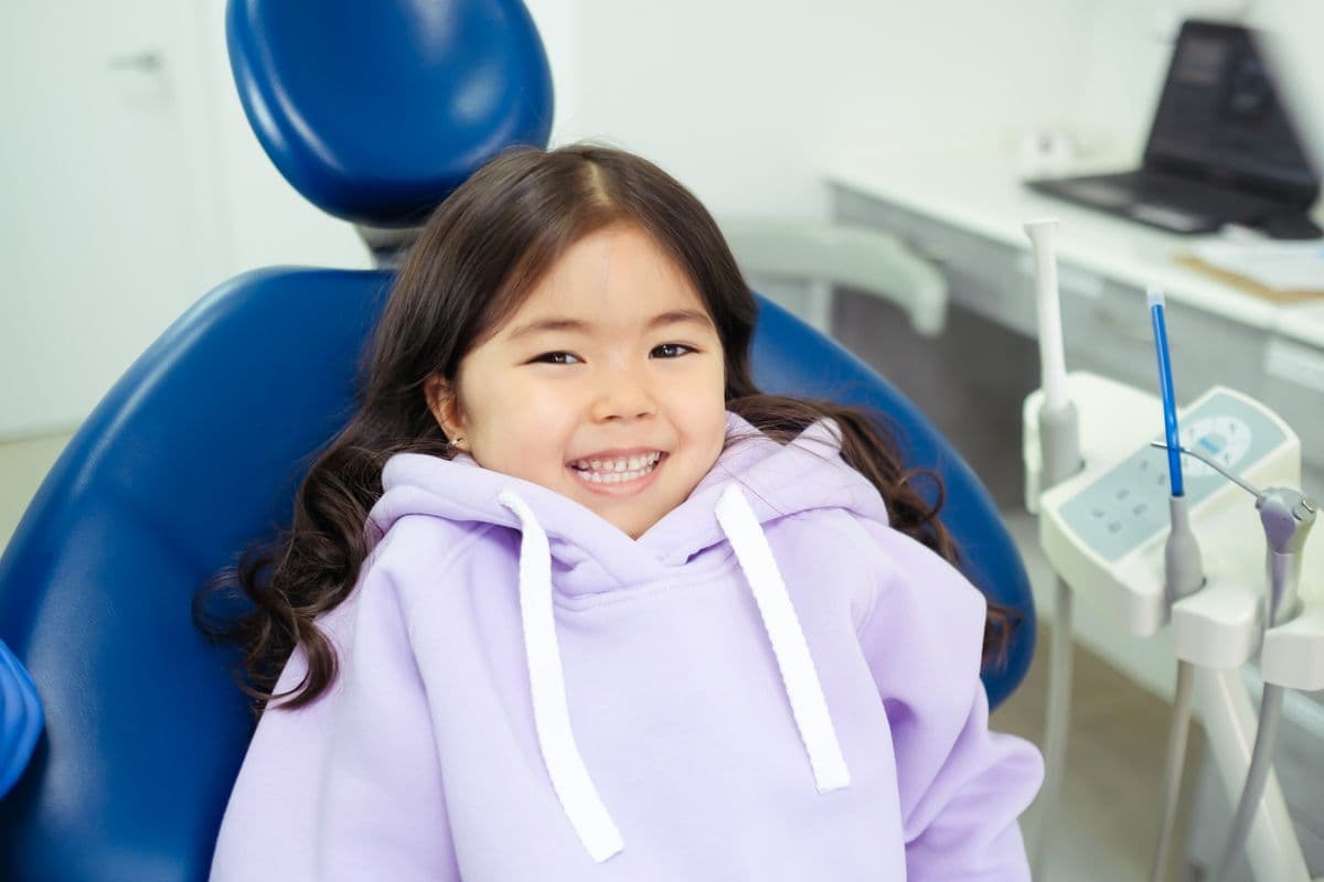 Baby teeth falling out Kharghar, smiling child in a dentist's chair at Reform Dental Clinic