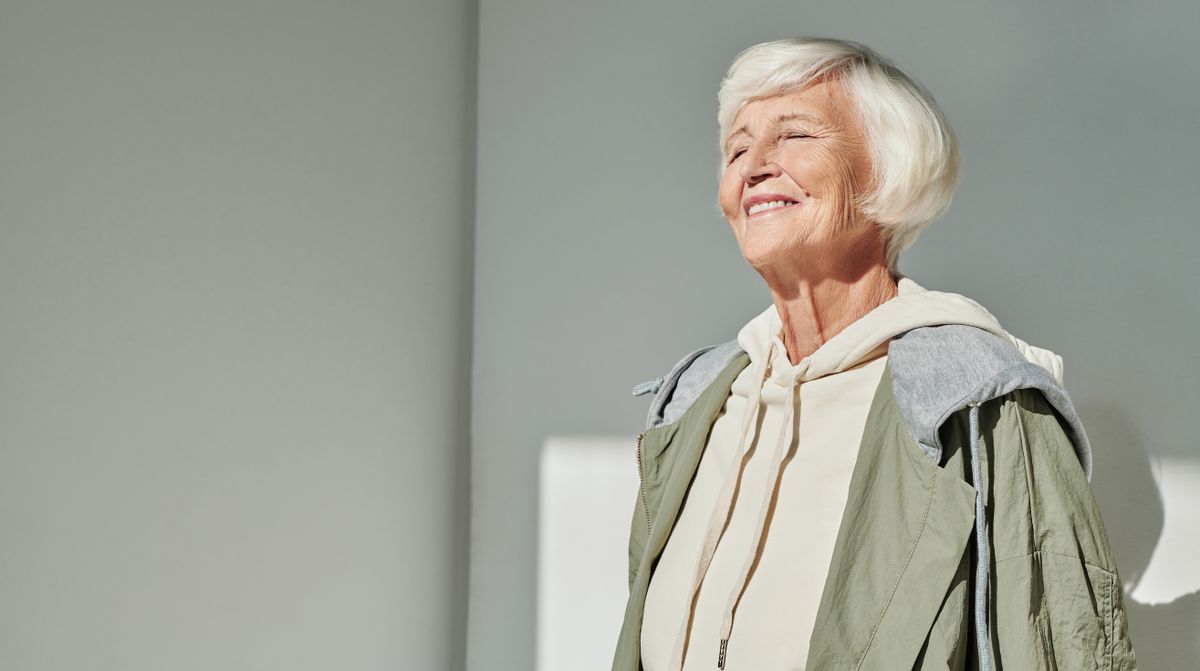 full mouth dental implants Kharghar, senior woman smiling after All-on-4 at Reform Dental Clinic Sector 15