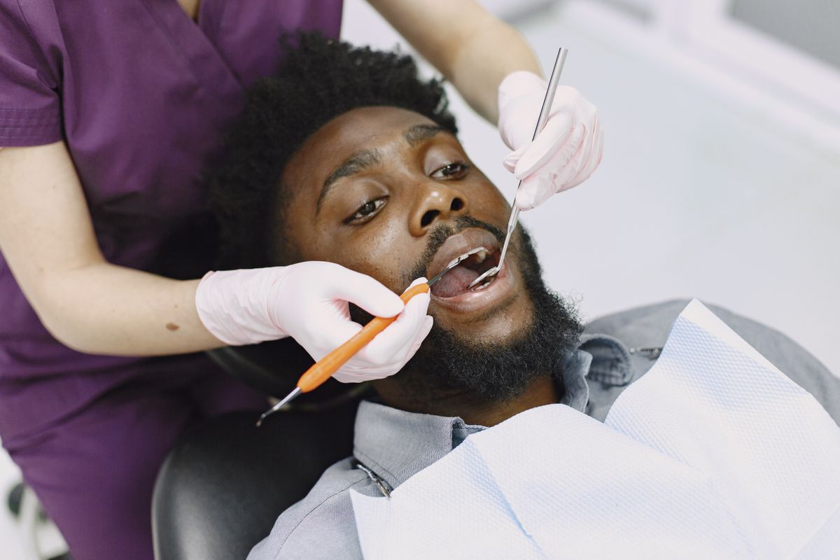 Dentist in Kharghar examining a patient's teeth during a routine checkup at Reform Dental Clinic Sector 15